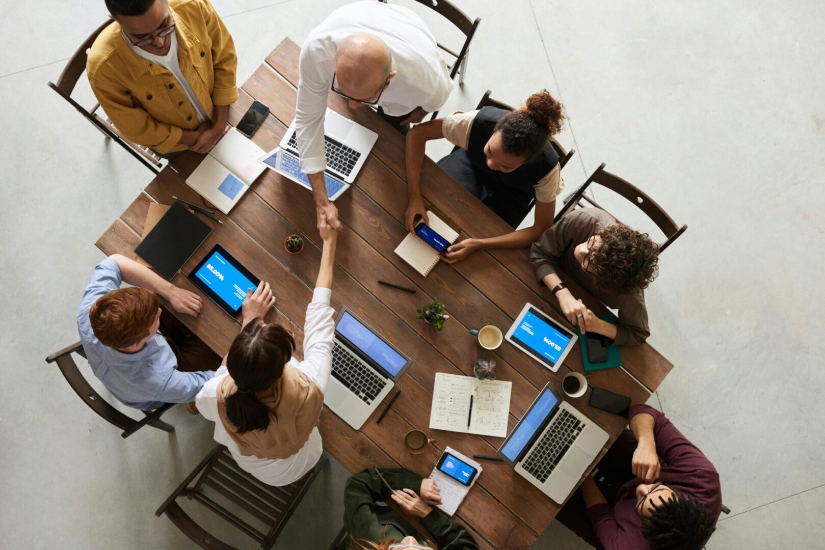 pexels-fauxels-3183197 A group of people sitting around a table with laptops.